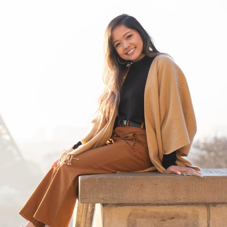 Tika Lestari smiling outdoors